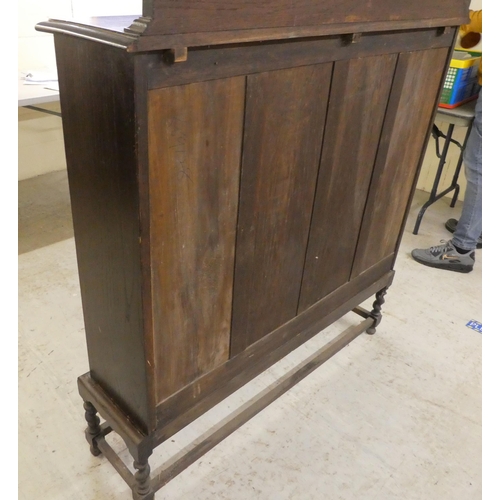 97 - A 1920s oak two door, glazed bookcase on stand  54