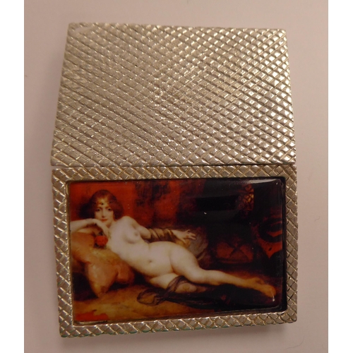 115 - A silver plated pill box, the hinged lid with an enamel tablet, depicting a nude