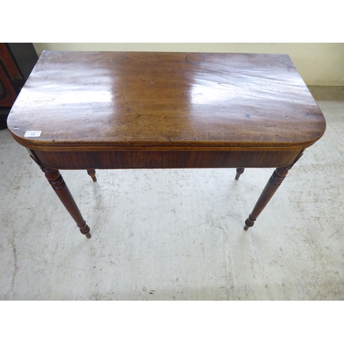 12 - A late George III mahogany tea table, raised on a rear gateleg action and turned legs  29