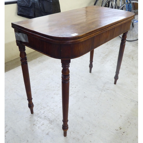 12 - A late George III mahogany tea table, raised on a rear gateleg action and turned legs  29