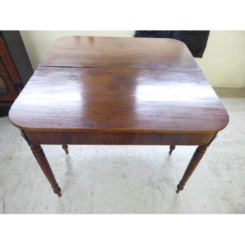 12 - A late George III mahogany tea table, raised on a rear gateleg action and turned legs  29