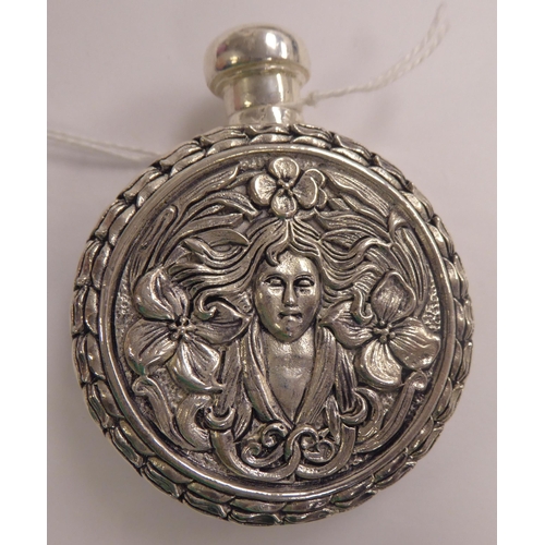 124 - An Art Nouveau influenced silver coloured metal perfume flask  stamped 800