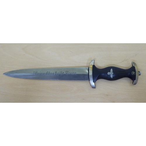 128 - A German World War II SS dagger, the ebony handgrip with emblems, the blade inscribed 'Meine Ehre he... 