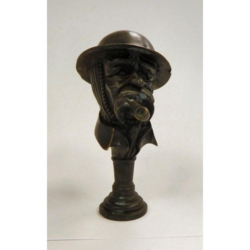 132 - A bronze 'Old Bill' pipe tamper