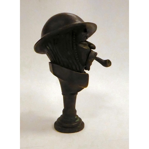 132 - A bronze 'Old Bill' pipe tamper