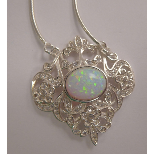 137 - A silver coloured metal opal and cubic zirconia set necklet, on a fine neckchain  stamped 925