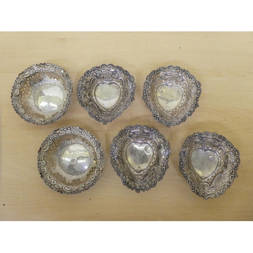 139 - Four silver heart shaped baskets; and two circular  mixed marks  all approx. 4