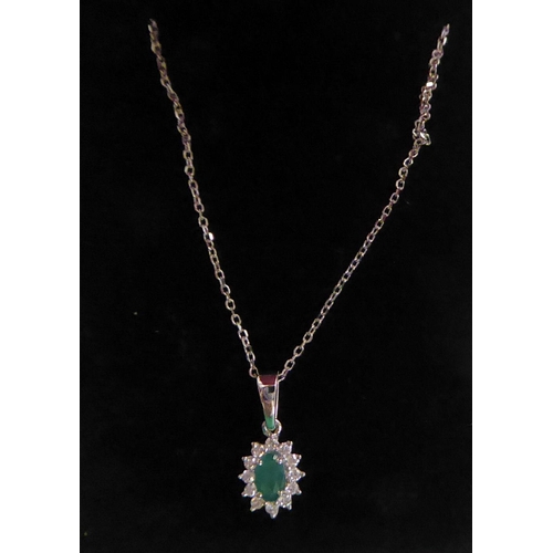 151 - An 18ct white gold, emerald and diamond set pendant, on a fine neckchain