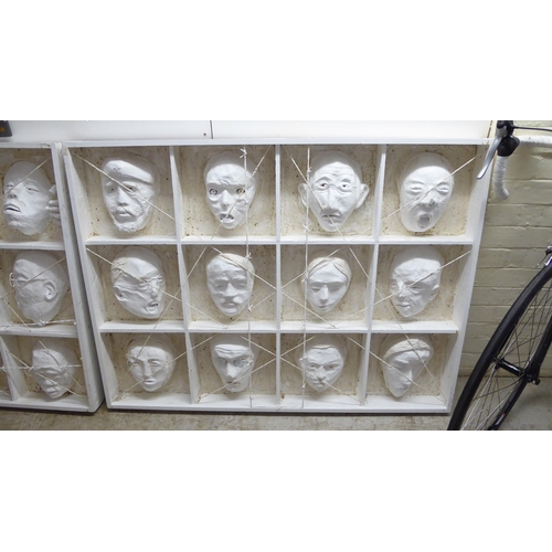 155 - Two papier mache and plywood art works, entitled 'Ghosts of the past', each comprising twelve masks ... 