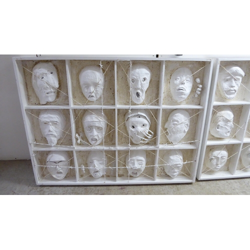 155 - Two papier mache and plywood art works, entitled 'Ghosts of the past', each comprising twelve masks ... 