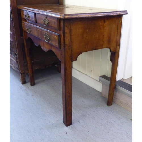 162 - A George III walnut lowboy with two short/one long drawer, raised on chamfered legs  28