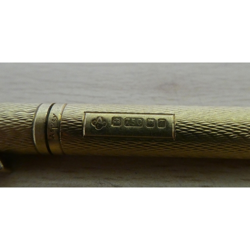 183 - An Asprey 18ct gold ballpoint pen with engine turned decoration