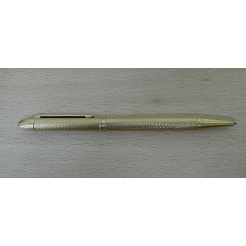 183 - An Asprey 18ct gold ballpoint pen with engine turned decoration