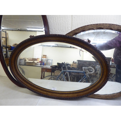 19 - Three similar early 20thC oval mirrors, in oak/mahogany frames  all approx. 19