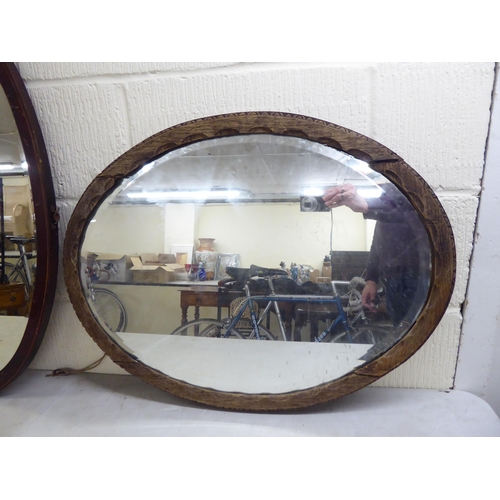 19 - Three similar early 20thC oval mirrors, in oak/mahogany frames  all approx. 19