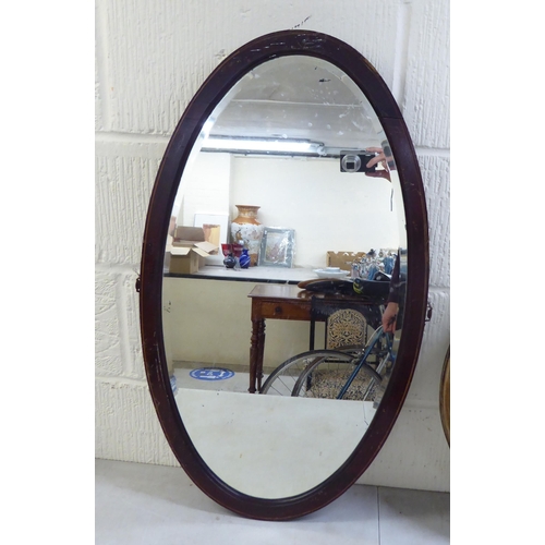 19 - Three similar early 20thC oval mirrors, in oak/mahogany frames  all approx. 19