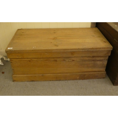 197 - An early 20thC pine trunk with straight sides and a hinged lid  15