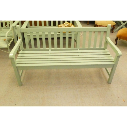 203 - A green painted garden bench, raised on square legs  59