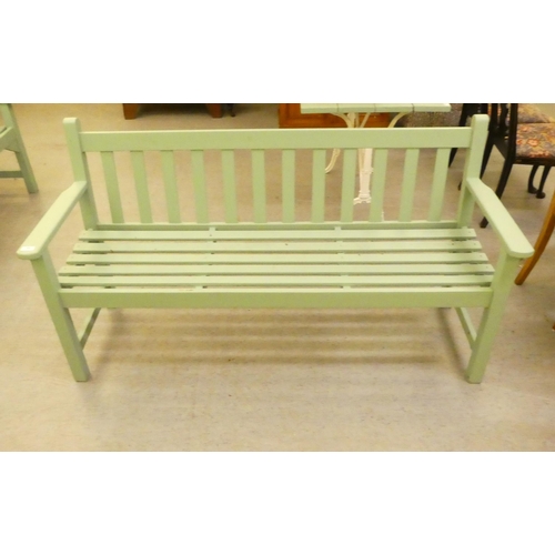 206 - A green painted garden bench, raised on square legs  62