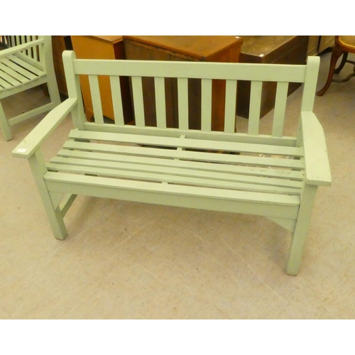 207 - A green painted garden bench, raised on square legs  51