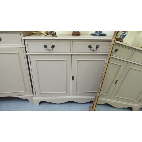 212 - Two 20thC peach coloured painted cabinets, each with two frieze drawers, over two panelled doors, ra... 