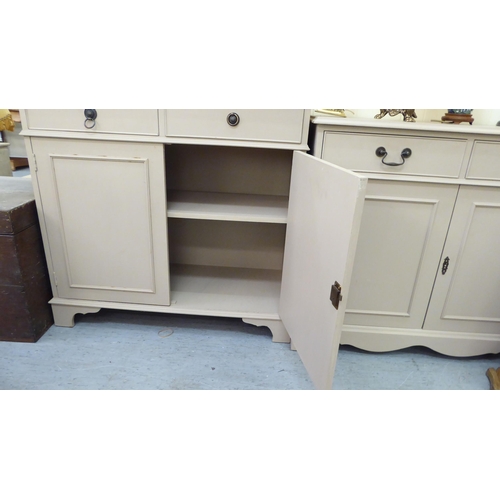 212 - Two 20thC peach coloured painted cabinets, each with two frieze drawers, over two panelled doors, ra... 