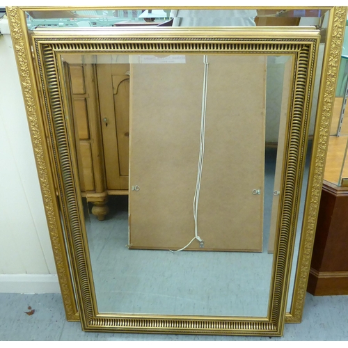 216 - Three similar mirrors, each in a moulded gilt frame  largest 43