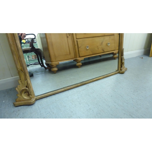 217 - An early 20thC overmantel mirror, set in a moulded gilt frame  42