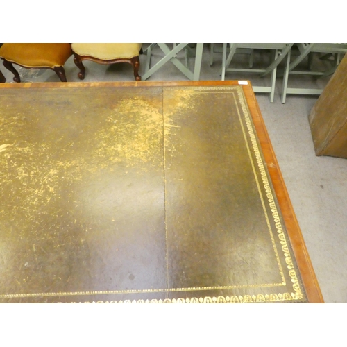 221 - A 20thC yewwood partner's desk with an arrangement of cupboard doors and drawers, on a plinth  ... 