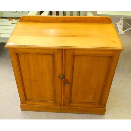 225 - An Edwardian mahogany two door side cabinet, on a plinth  34