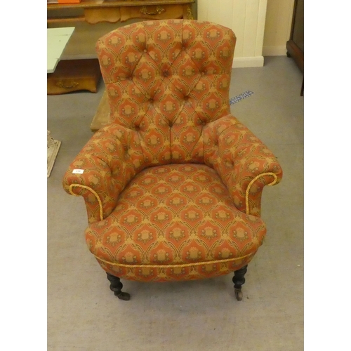 239 - An early 20thC and later fabric upholstered, enclosed arm salon chair, raised on turned legs and cas... 