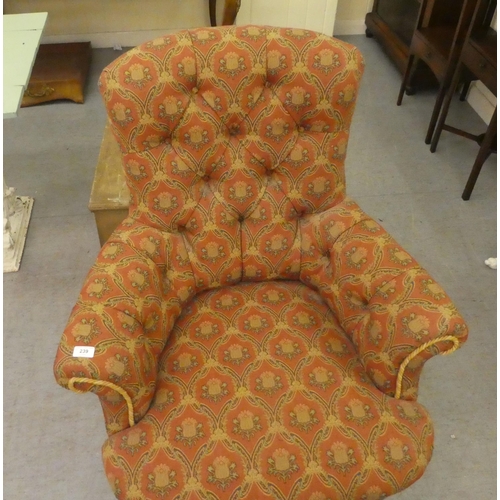 239 - An early 20thC and later fabric upholstered, enclosed arm salon chair, raised on turned legs and cas... 