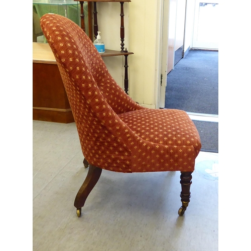 241 - A late 19thC rosewood framed and later red fabric upholstered nursing chair, raised on turned forele... 