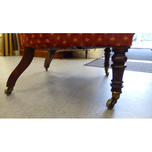 241 - A late 19thC rosewood framed and later red fabric upholstered nursing chair, raised on turned forele... 