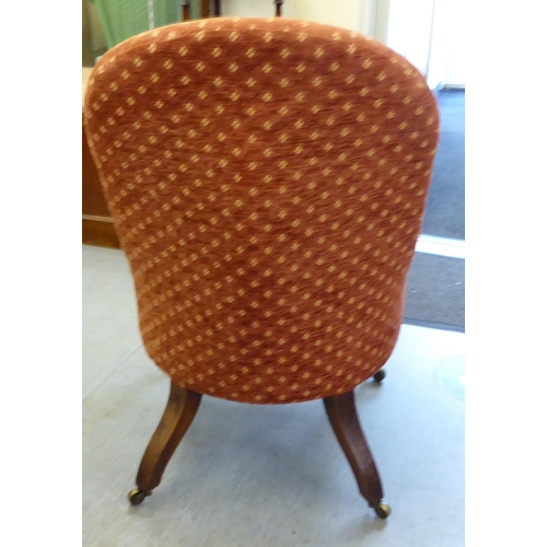 241 - A late 19thC rosewood framed and later red fabric upholstered nursing chair, raised on turned forele... 