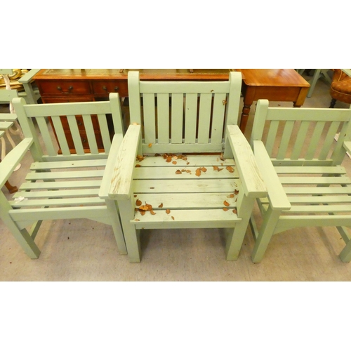 253 - Three green painted garden armchairs, raised on square forelegs