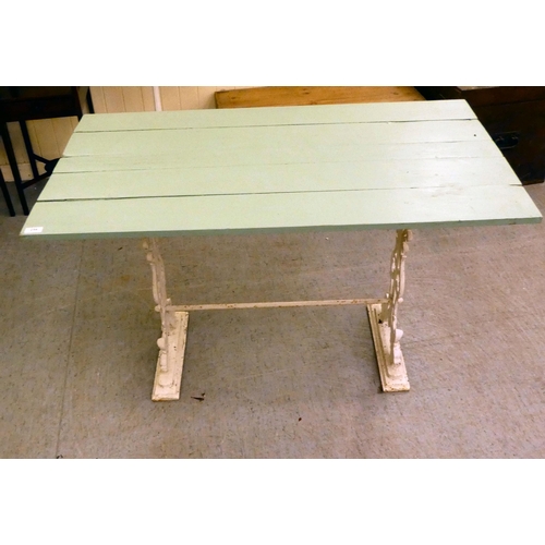 254 - A Victorian style, white painted cast iron framed terrace table with a green painted, planked top&nb... 