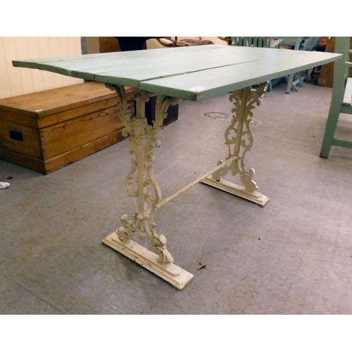 254 - A Victorian style, white painted cast iron framed terrace table with a green painted, planked top&nb... 