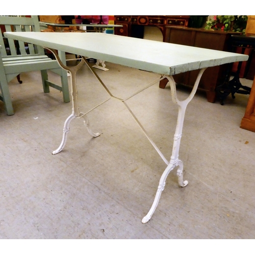 255 - A Victorian style, white painted cast iron framed terrace table with a green painted, planked top&nb... 