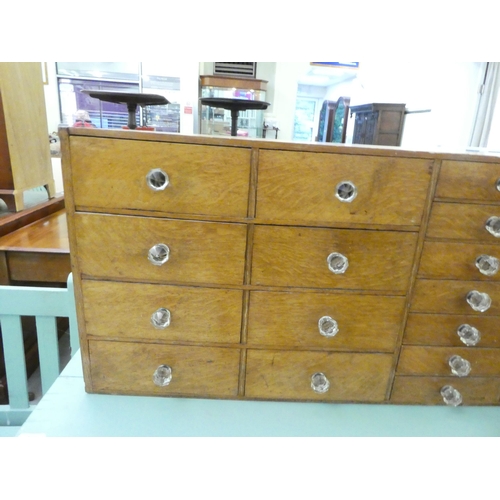 256 - A 1920s oak twenty-two drawer table-top tool/storage cabinet  18