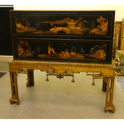 272 - An early 20thC Oriental black painted and gilt decorated, two drawer cabinet-on-stand  35