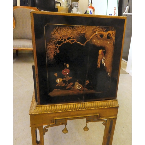 272 - An early 20thC Oriental black painted and gilt decorated, two drawer cabinet-on-stand  35