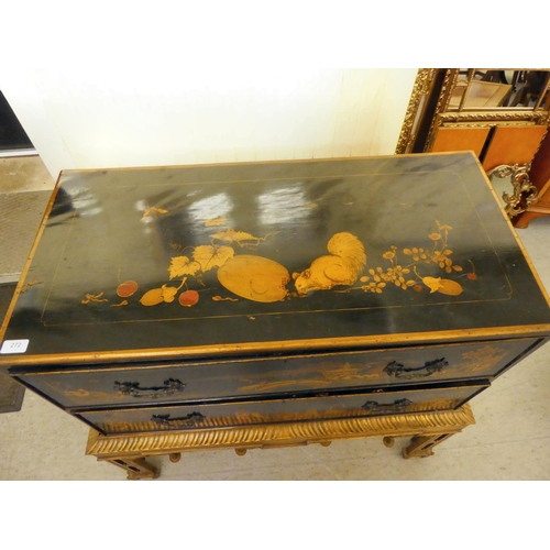 272 - An early 20thC Oriental black painted and gilt decorated, two drawer cabinet-on-stand  35