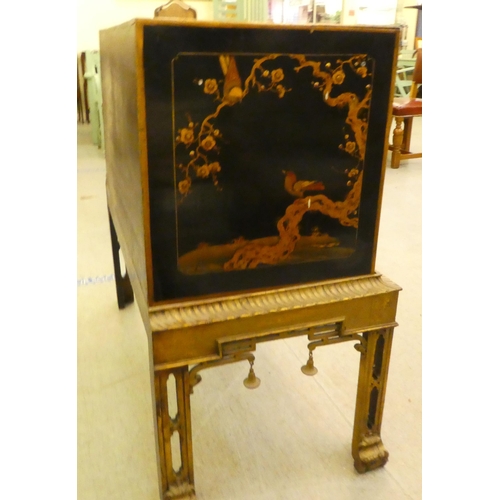 272 - An early 20thC Oriental black painted and gilt decorated, two drawer cabinet-on-stand  35