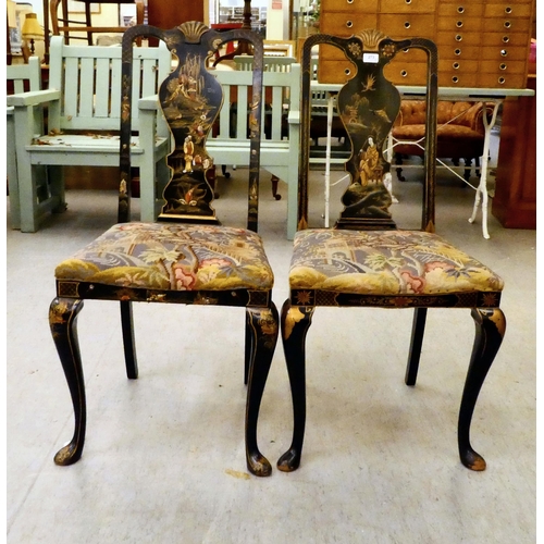 273 - Two early/mid 20thC Oriental black painted and gilt decorated splat back hall chairs, raised on cabr... 