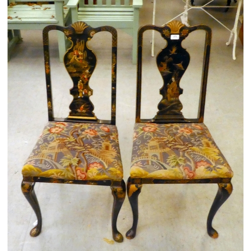 273 - Two early/mid 20thC Oriental black painted and gilt decorated splat back hall chairs, raised on cabr... 