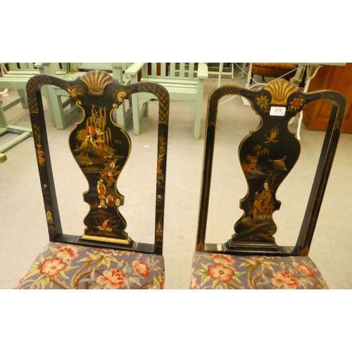 273 - Two early/mid 20thC Oriental black painted and gilt decorated splat back hall chairs, raised on cabr... 