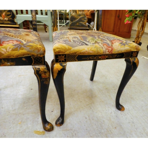 273 - Two early/mid 20thC Oriental black painted and gilt decorated splat back hall chairs, raised on cabr... 