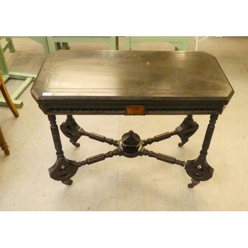 275 - An Edwardian ebonised card table, the foldover, rotating top raised on ring turned legs  37