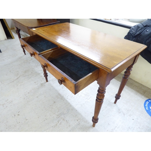 29 - A mid Victorian mahogany two drawer side table, raised on turned, tapered legs  30